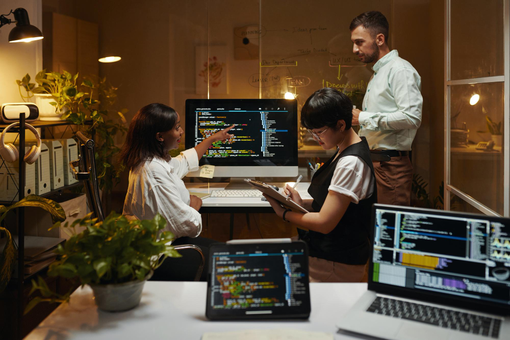 Web Development Company in Zirakpur Web development company in Zirakpur professional team collaborating late at night on code optimization and website responsiveness.