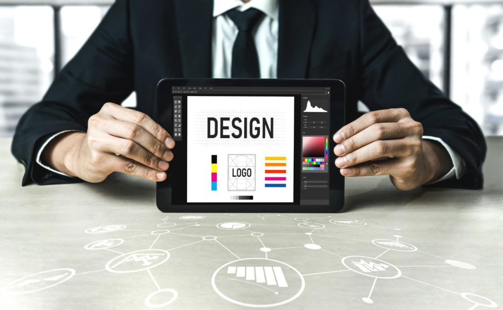 Graphic designer showing a custom logo design draft and brand identity guidelines on a digital tablet screen.