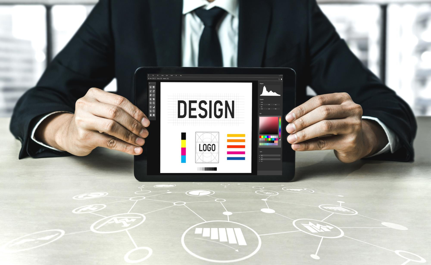 Graphic designer showing a custom logo design draft and brand identity guidelines on a digital tablet screen.