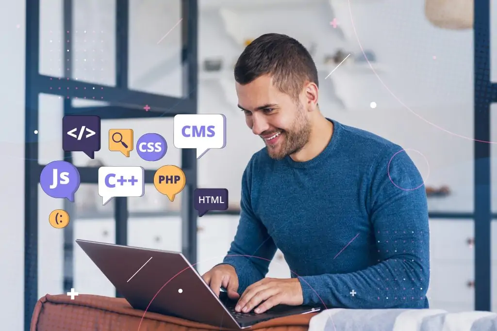 A smiling developer working on a laptop with floating 3D icons representing HTML, CSS, JavaScript, PHP, C++, and CMS, representing modern web development companies in Dubai.